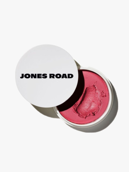 Jones Road Miracle Balm top view of a pink jar of cream blush with white lid ajar on light gray background